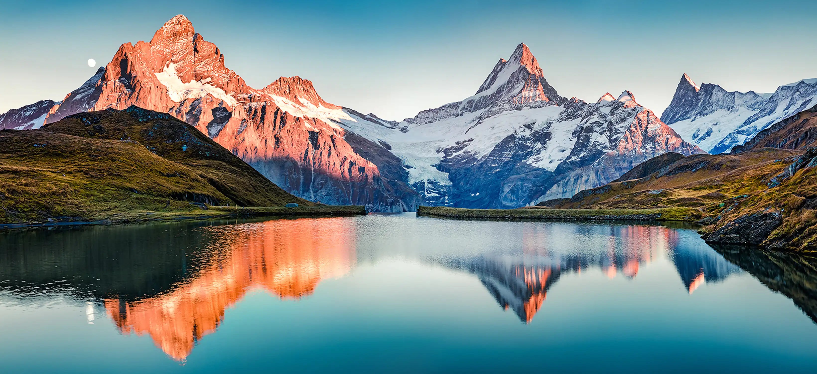 Fantastic evening panorama of Bachalp lake / Bachalpsee, Switzerland. Picturesque autumn sunset in Swiss alps, Grindelwald, Bernese Oberland, Europe. Beauty of nature concept background